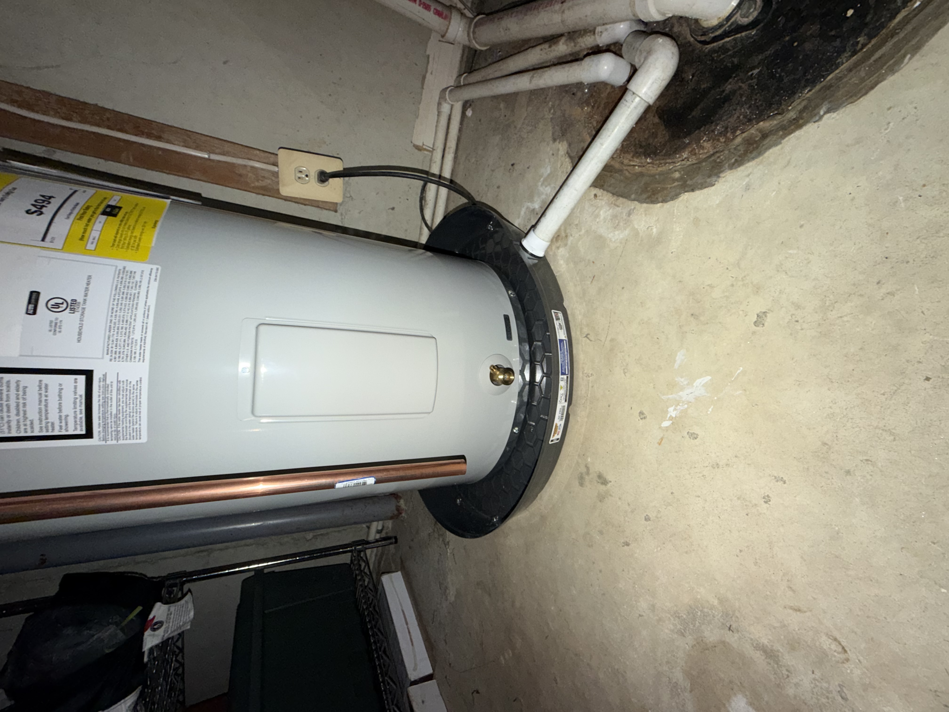 New Bradford White water heater — drain pan with PVC drain line routed to sump and T&P per code