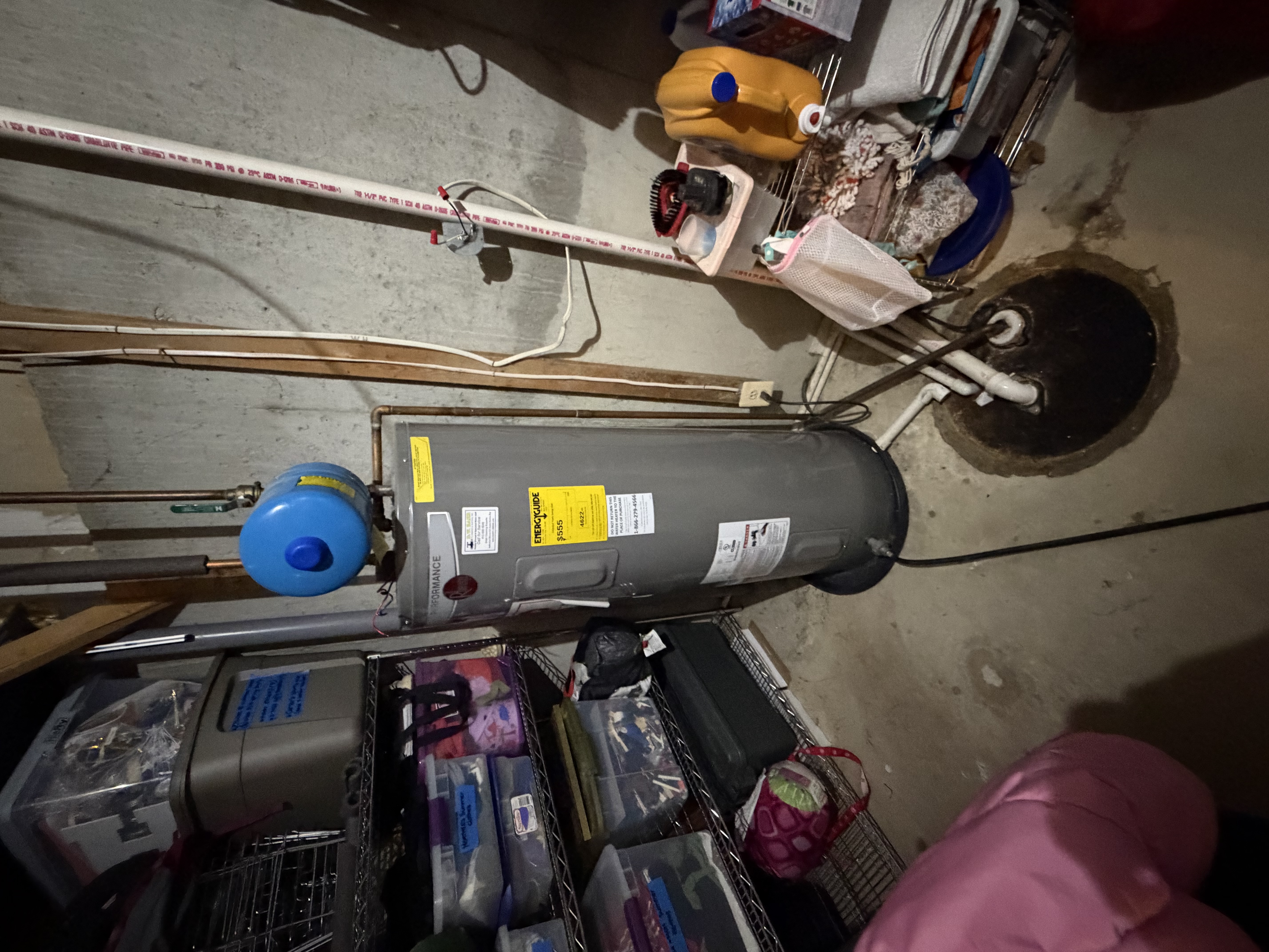 Existing Rheem water heater with code violations — unstrapped expansion tank and T&P improperly routed to sump